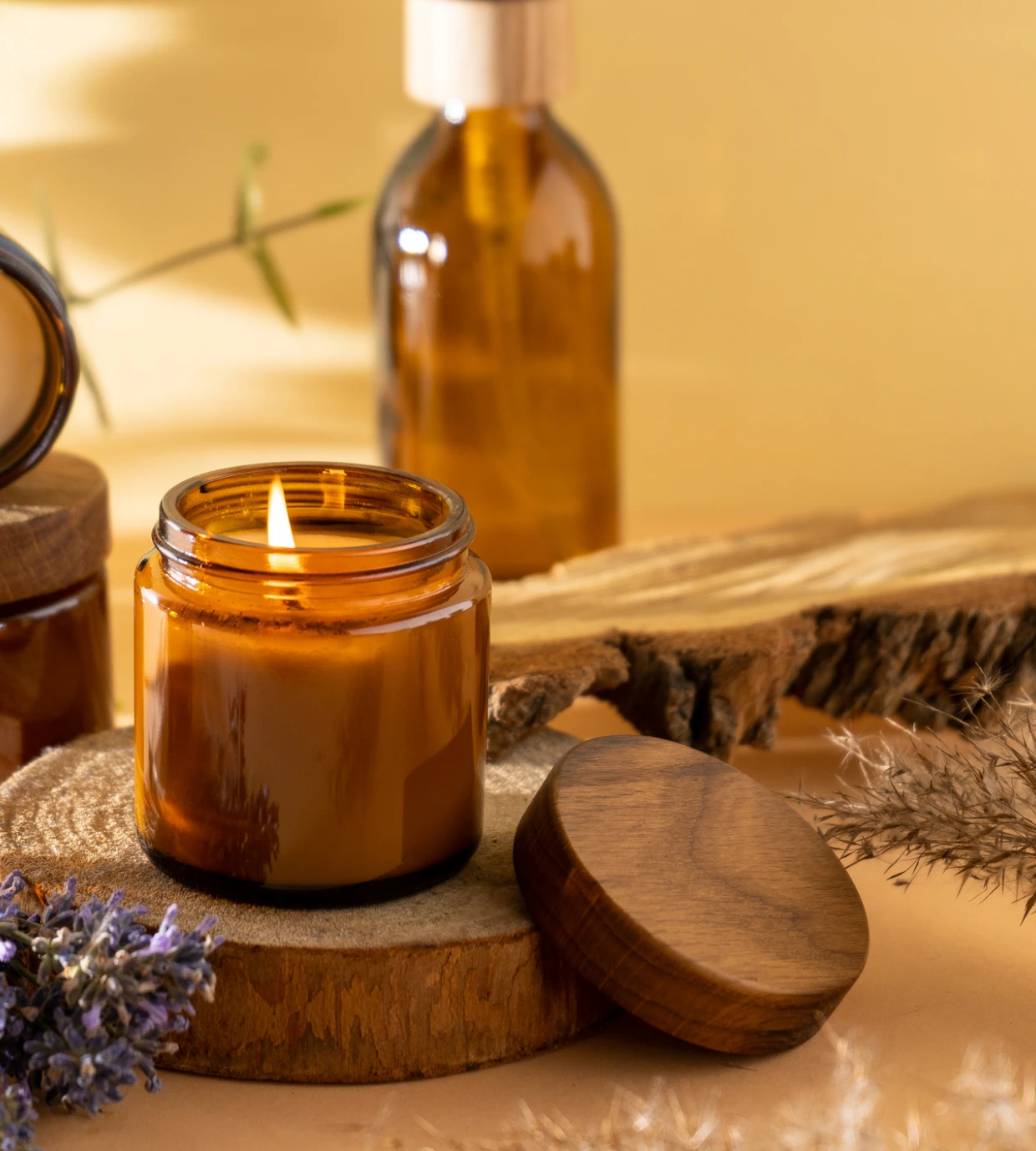 Lit candle on wooden surface