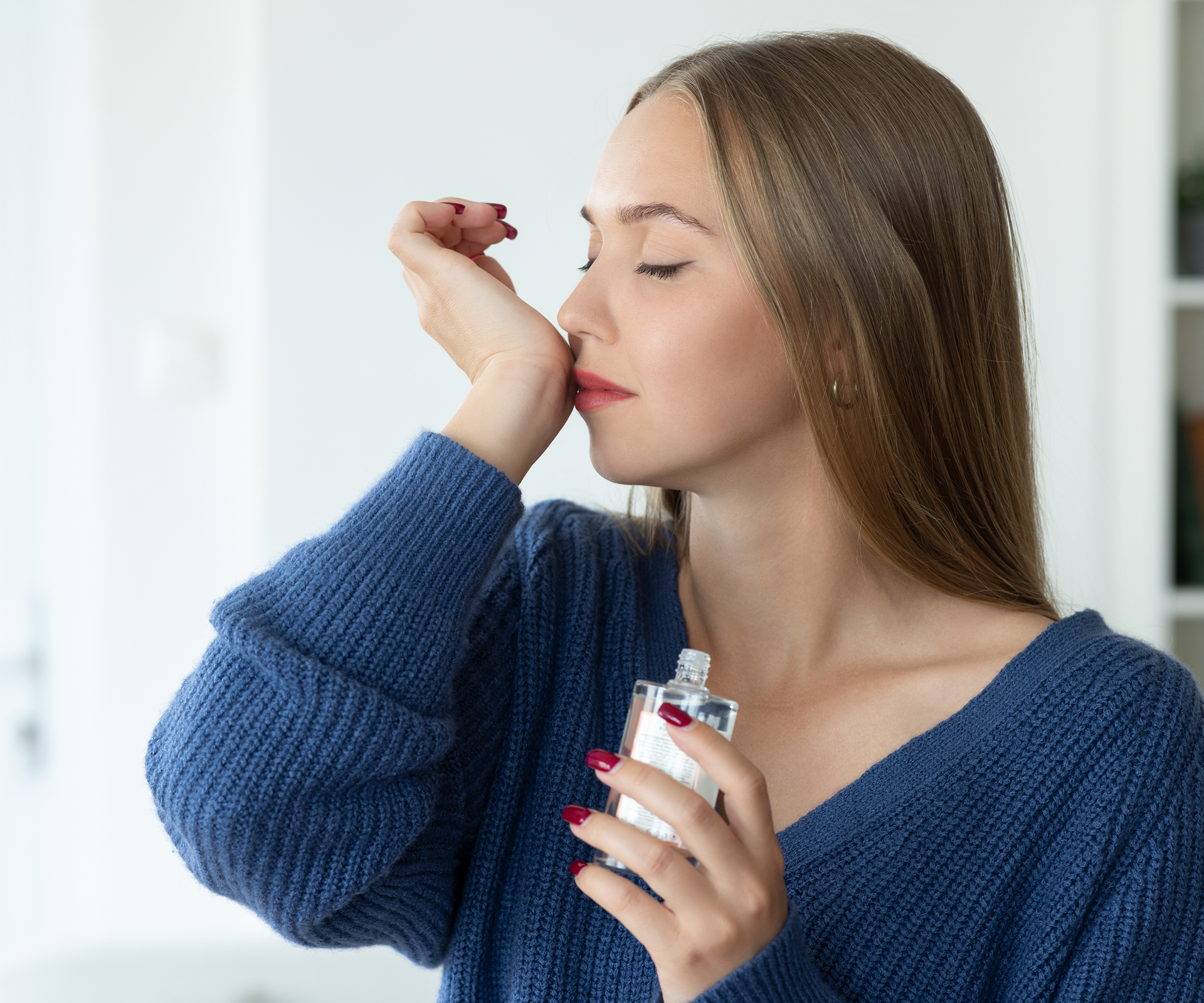 Woman enjoying perfume scent